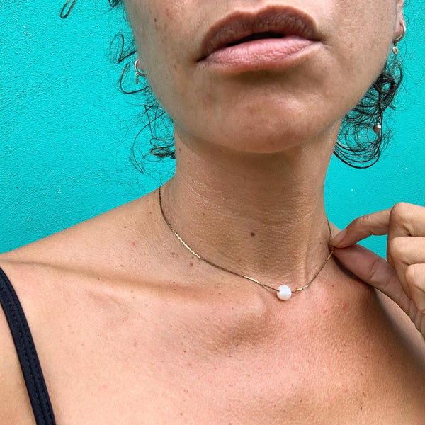 Freshwater pearl floating on a vintage brass box snake chain