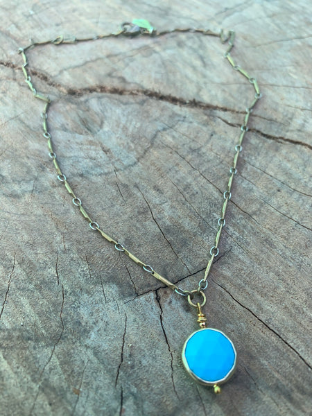 Round faceted turquoise bezel pendant. Vintage brass bar chain.