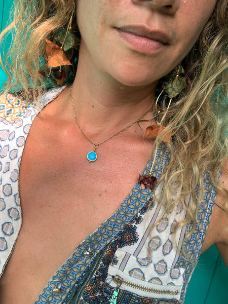 Round faceted turquoise bezel pendant. Vintage brass bar chain.