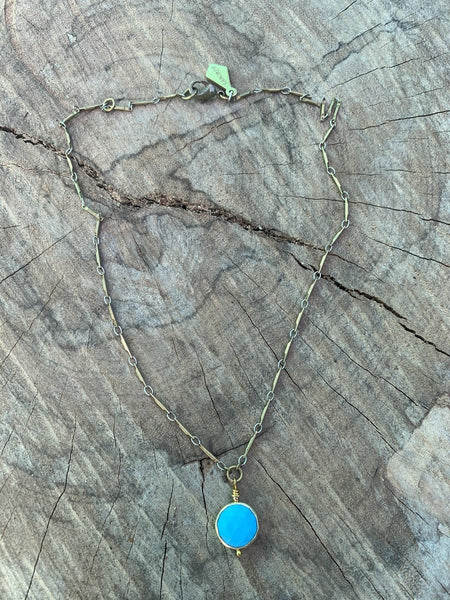 Round faceted turquoise bezel pendant. Vintage brass bar chain.