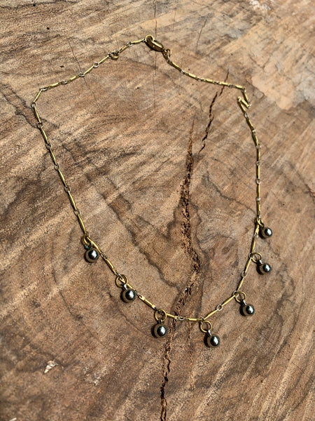 Silver curb link chain with pyrite and brass bar detail
