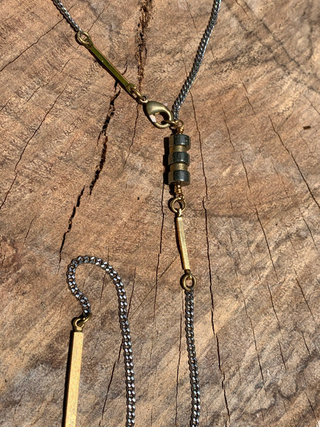 Silver curb link chain with pyrite and brass bar detail