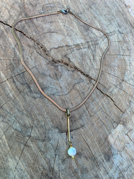 Round faceted turquoise bezel pendant. Vintage brass bar chain.