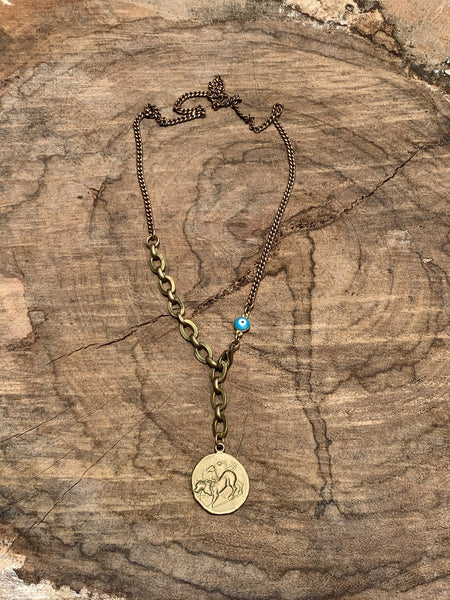 Round faceted turquoise bezel pendant. Vintage brass bar chain.